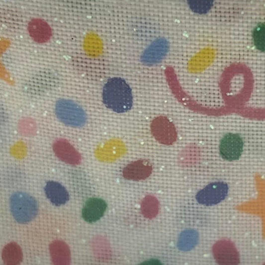 Decorative fabric with colorful polka dots and ribbons on a beige background