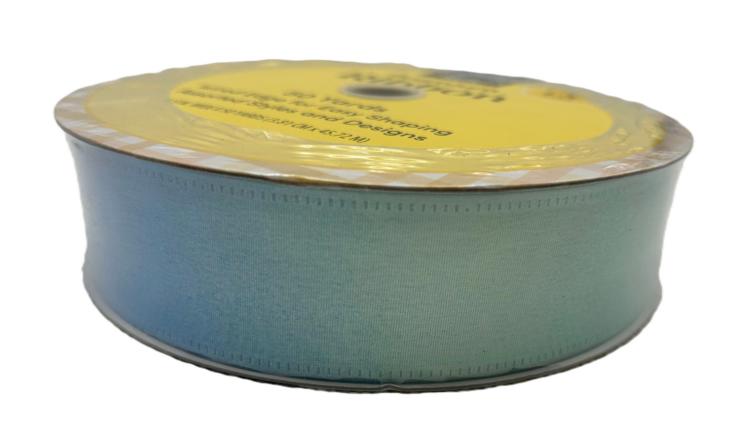 Spool of green ribbon with a yellow label on a white background
