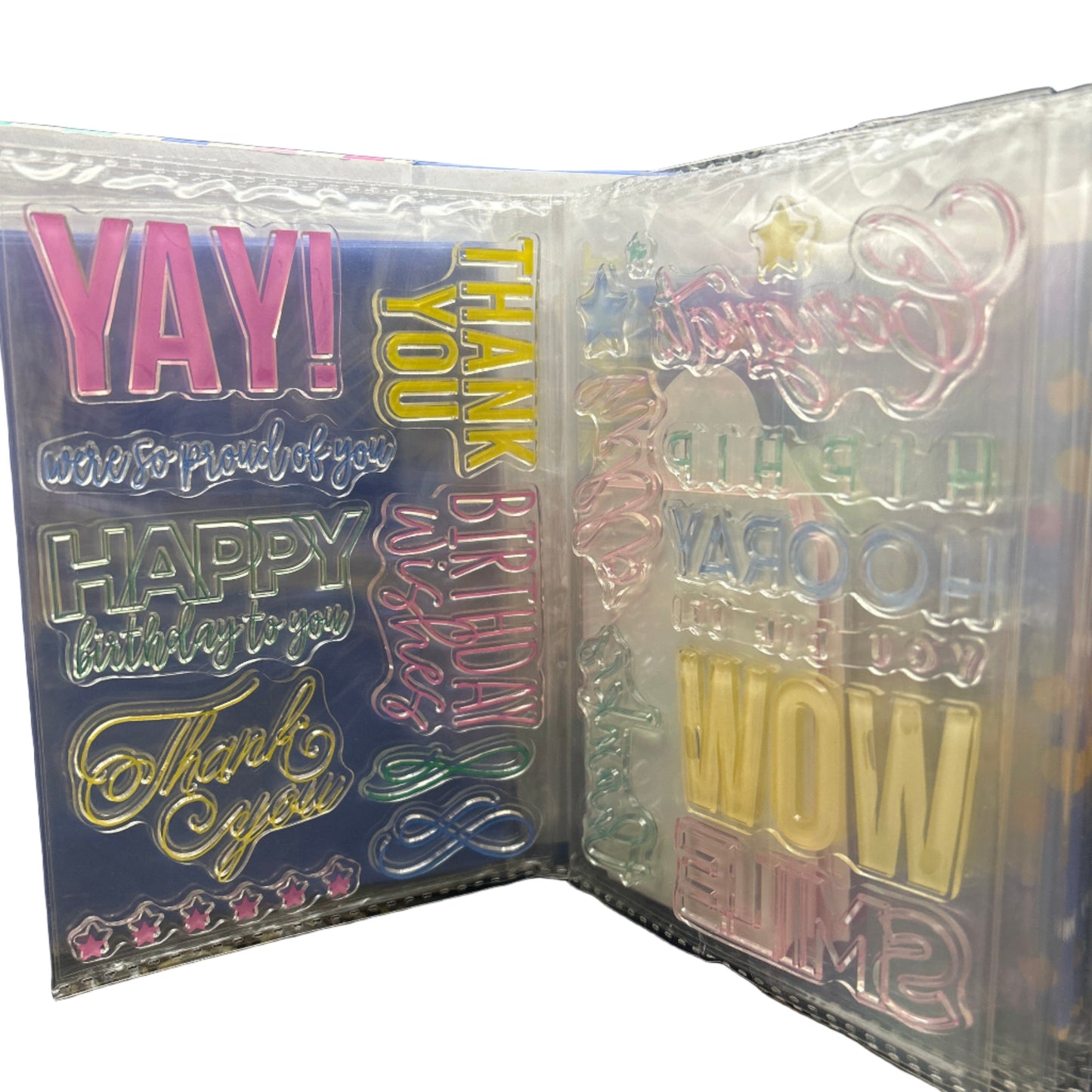 Packaged birthday-themed stickers with colorful text on a dark surface