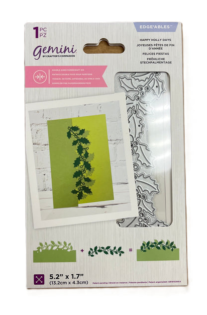 Packaging of Gemini stamp set with holly design on a white background