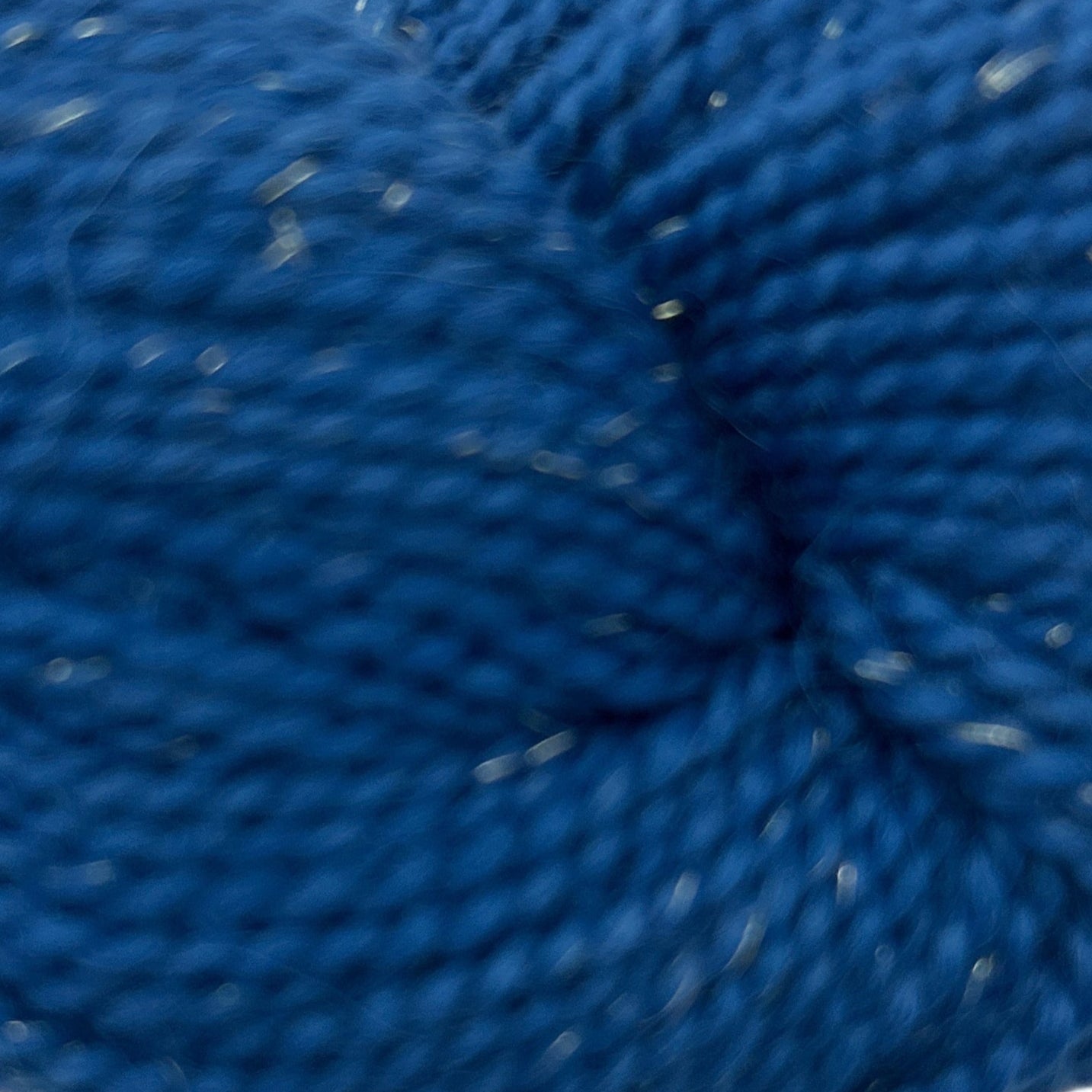 Blue skein of yarn on a white background