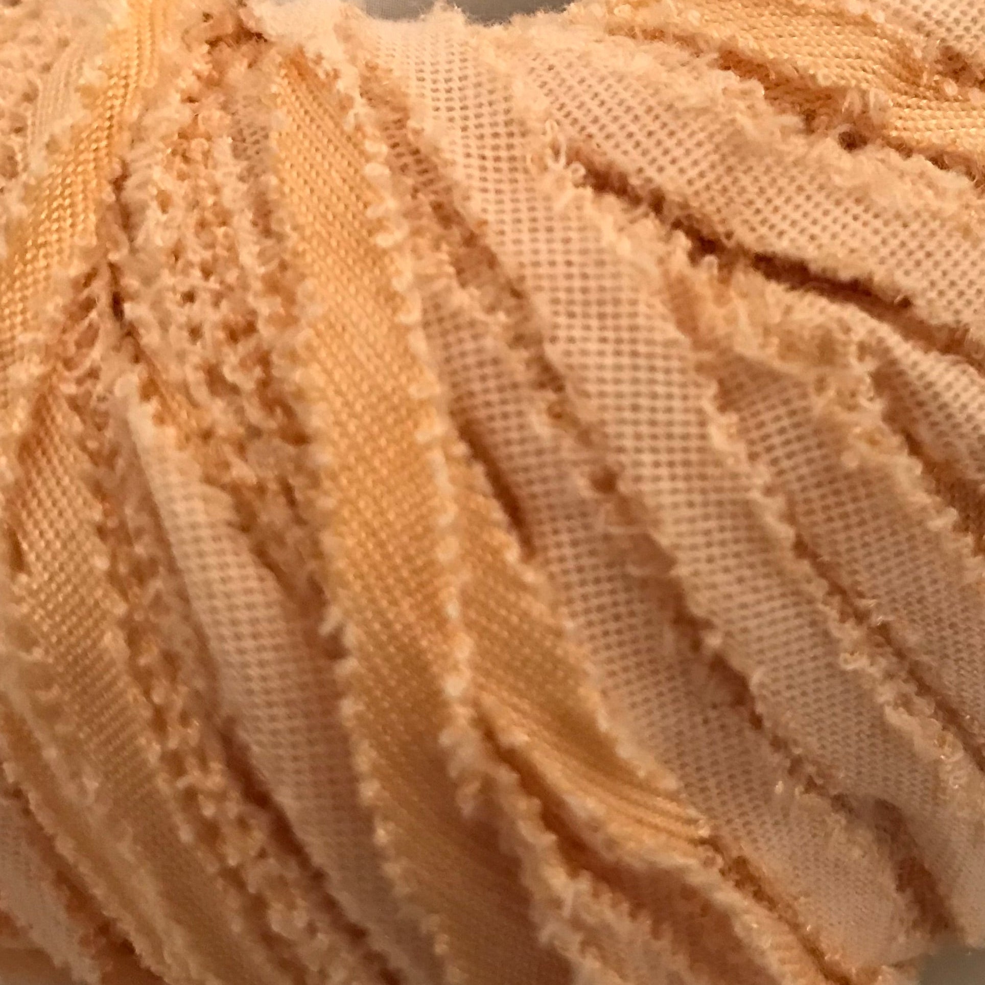 Ball of beige yarn with a label on a light background
