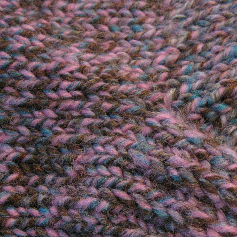 Close-up of a textured fabric with pink and brown tones