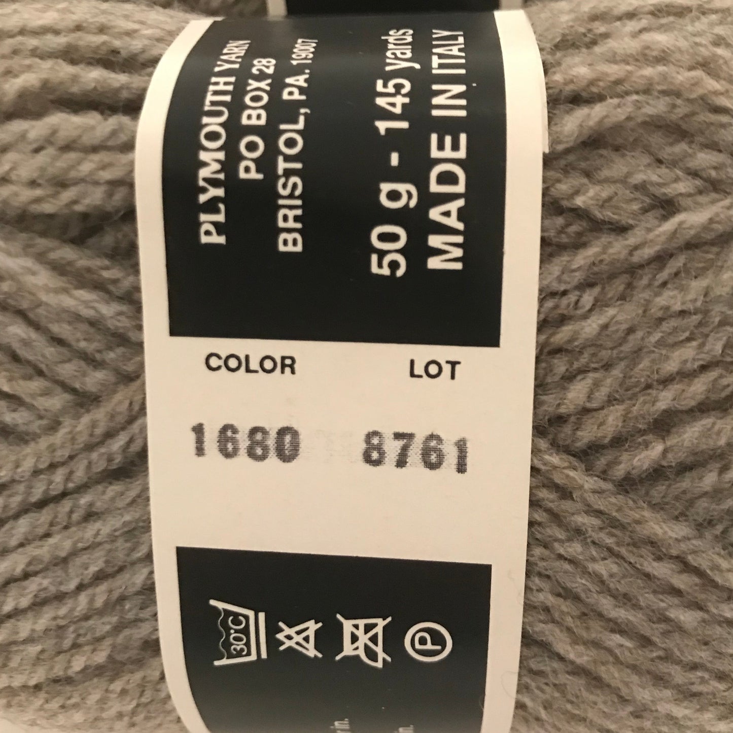 Close-up of Plymouth Yarn label on gray yarn ball