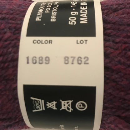 Close-up of a skein of yarn with a label on a beige background