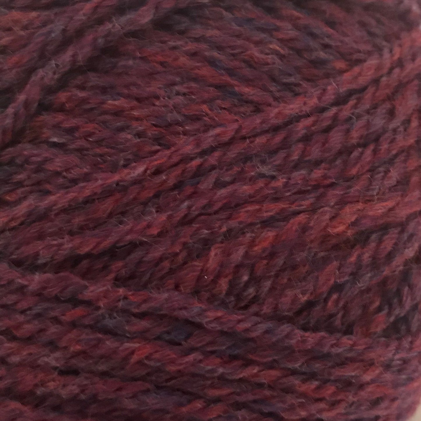 Close-up of a ball of dark red yarn