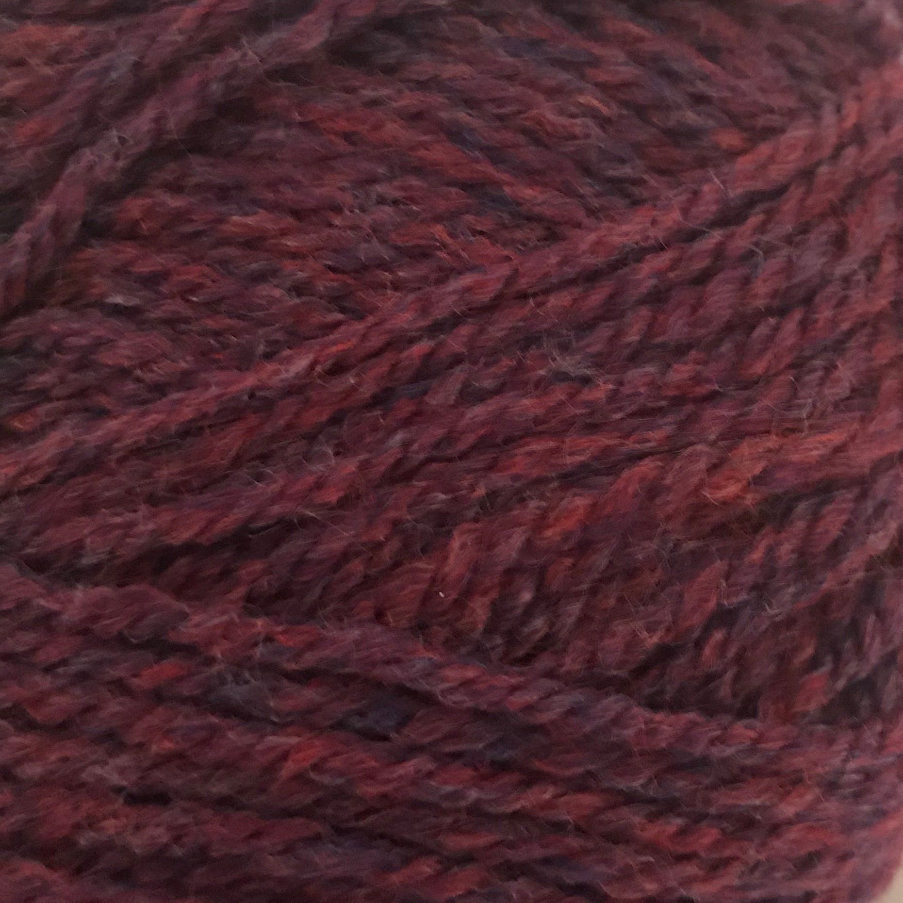 Close-up of a ball of dark red yarn