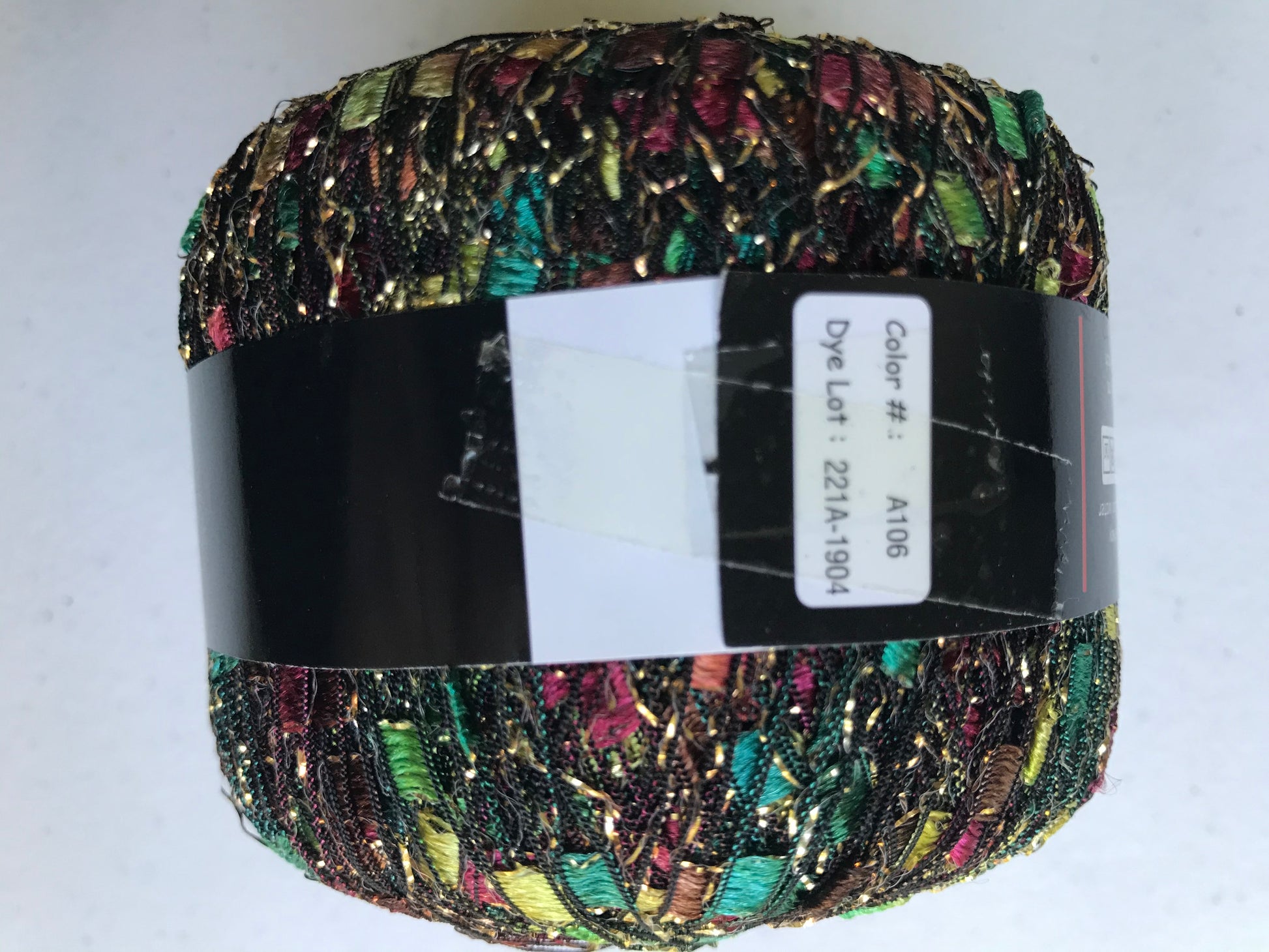 Multicolored yarn ball with a label on a white background