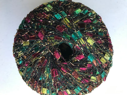 Multicolored beaded donut-shaped object on a white background