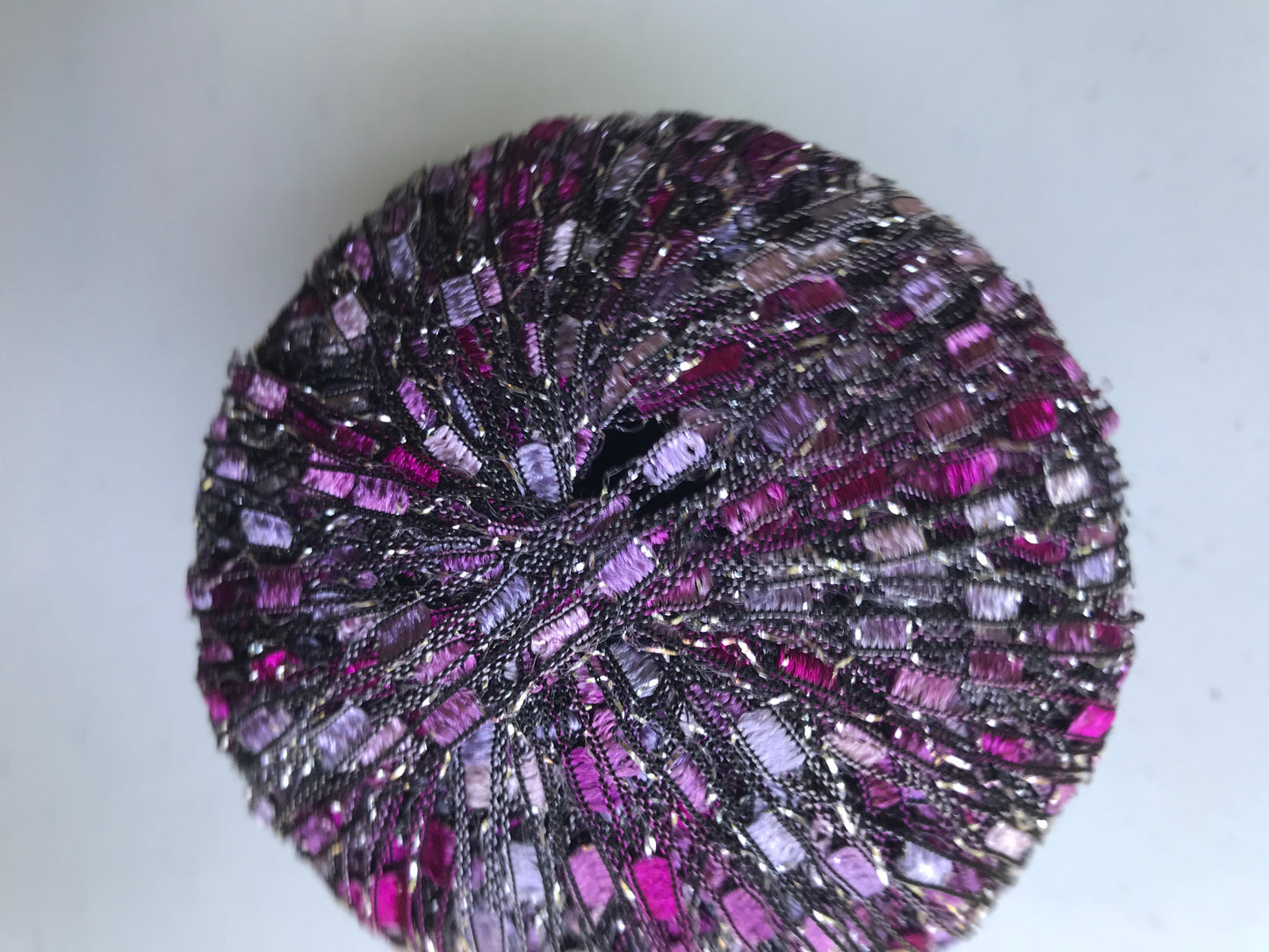 Close-up of a purple and black textured ball on a light background