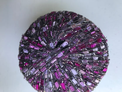 Close-up of a purple and black textured ball on a light background