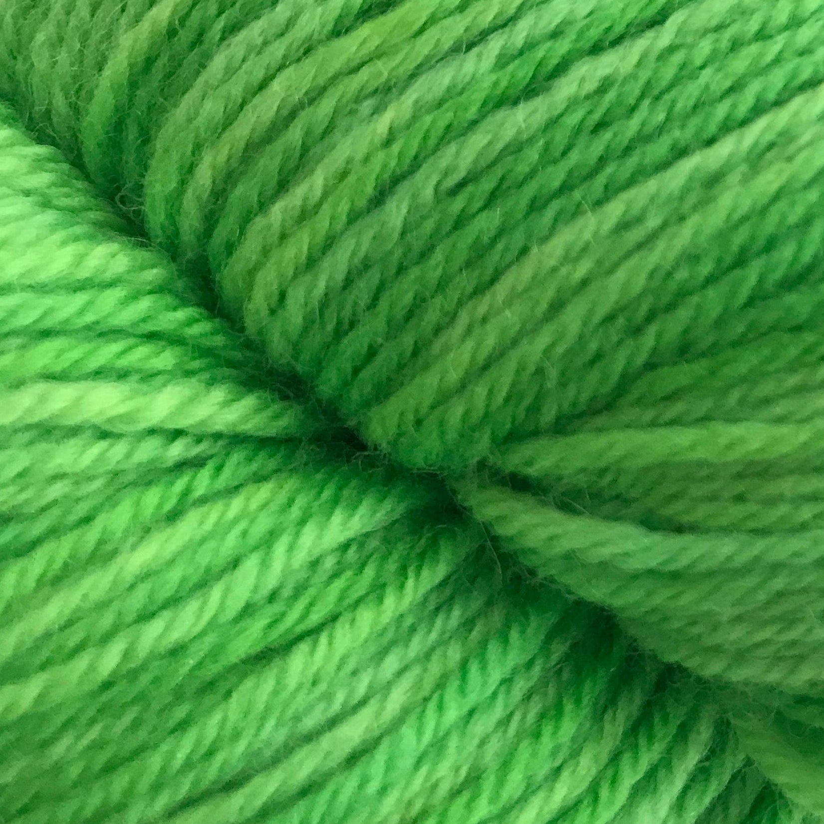 Green skein of yarn on a white background