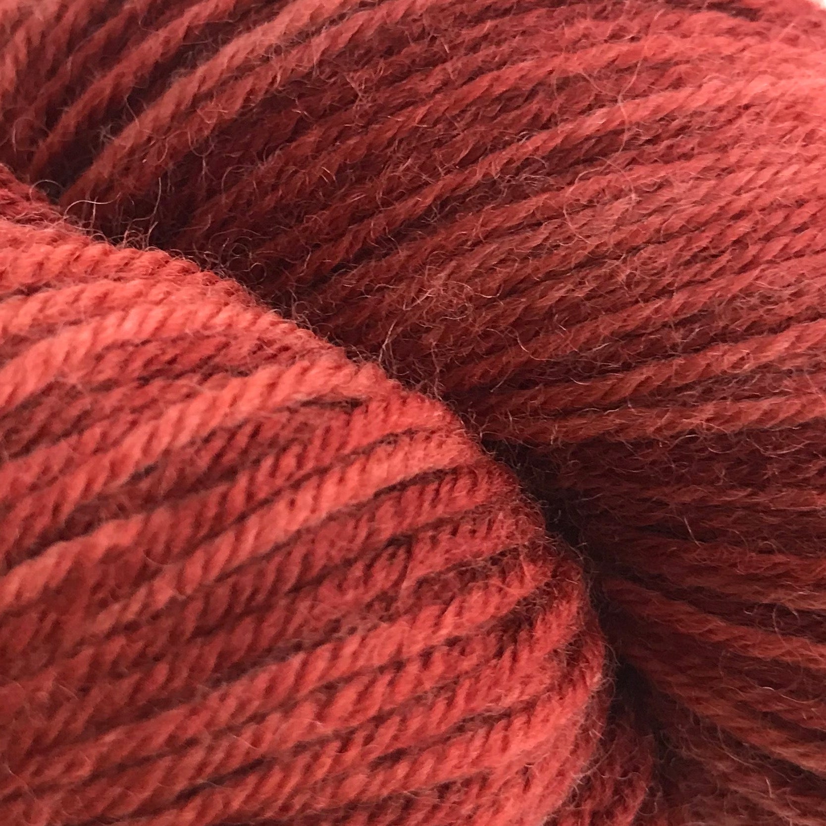 Red skein of yarn on a white background