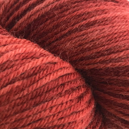 Red skein of yarn on a white background