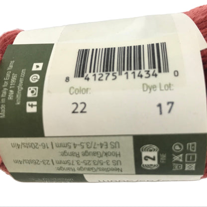 Red skein of yarn with a label showing product details on a white background