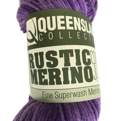 Purple skein of yarn with a label on a white background
