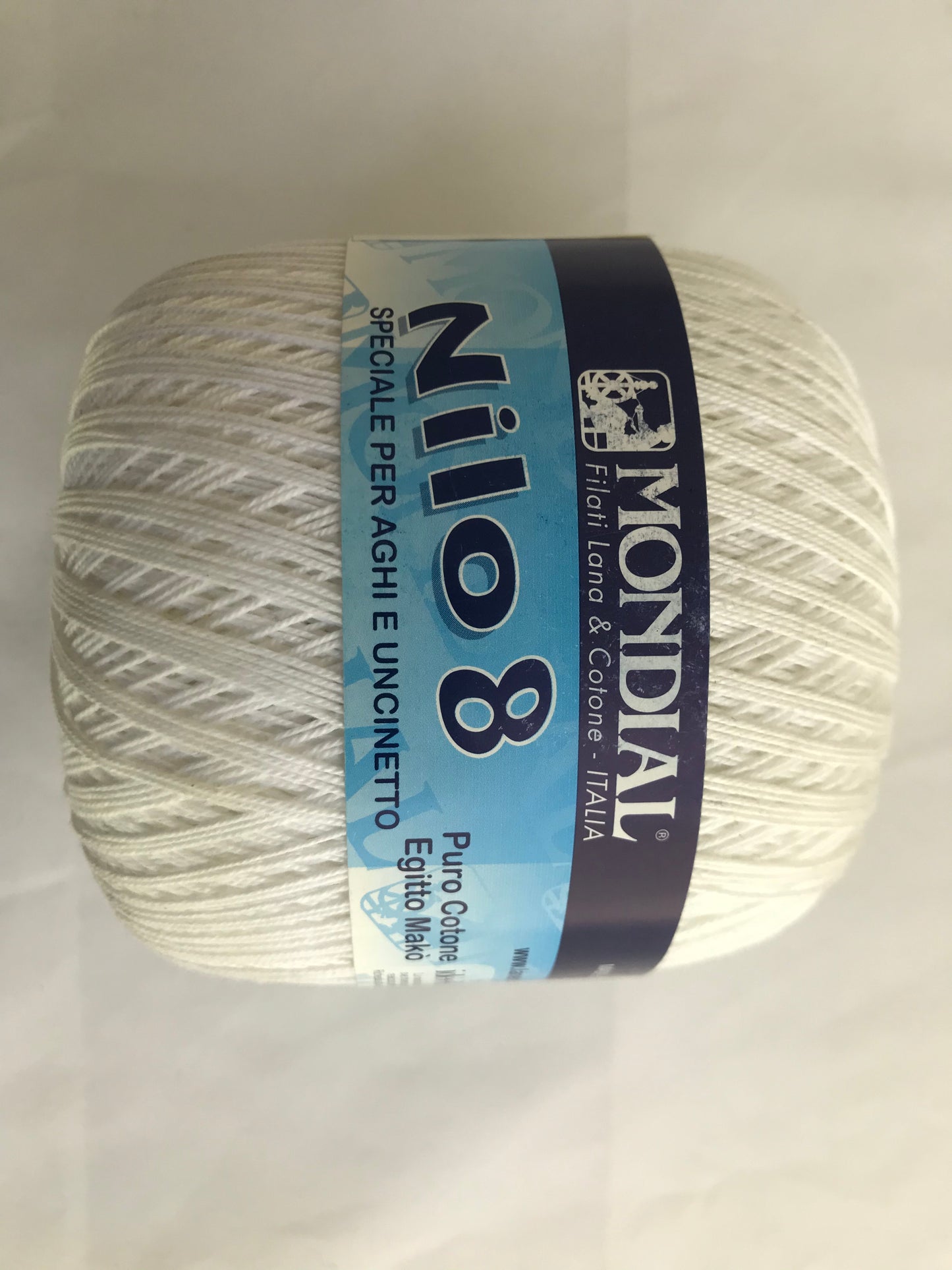 Ball of yarn with Mondial Nilo 8 label on a light gray background