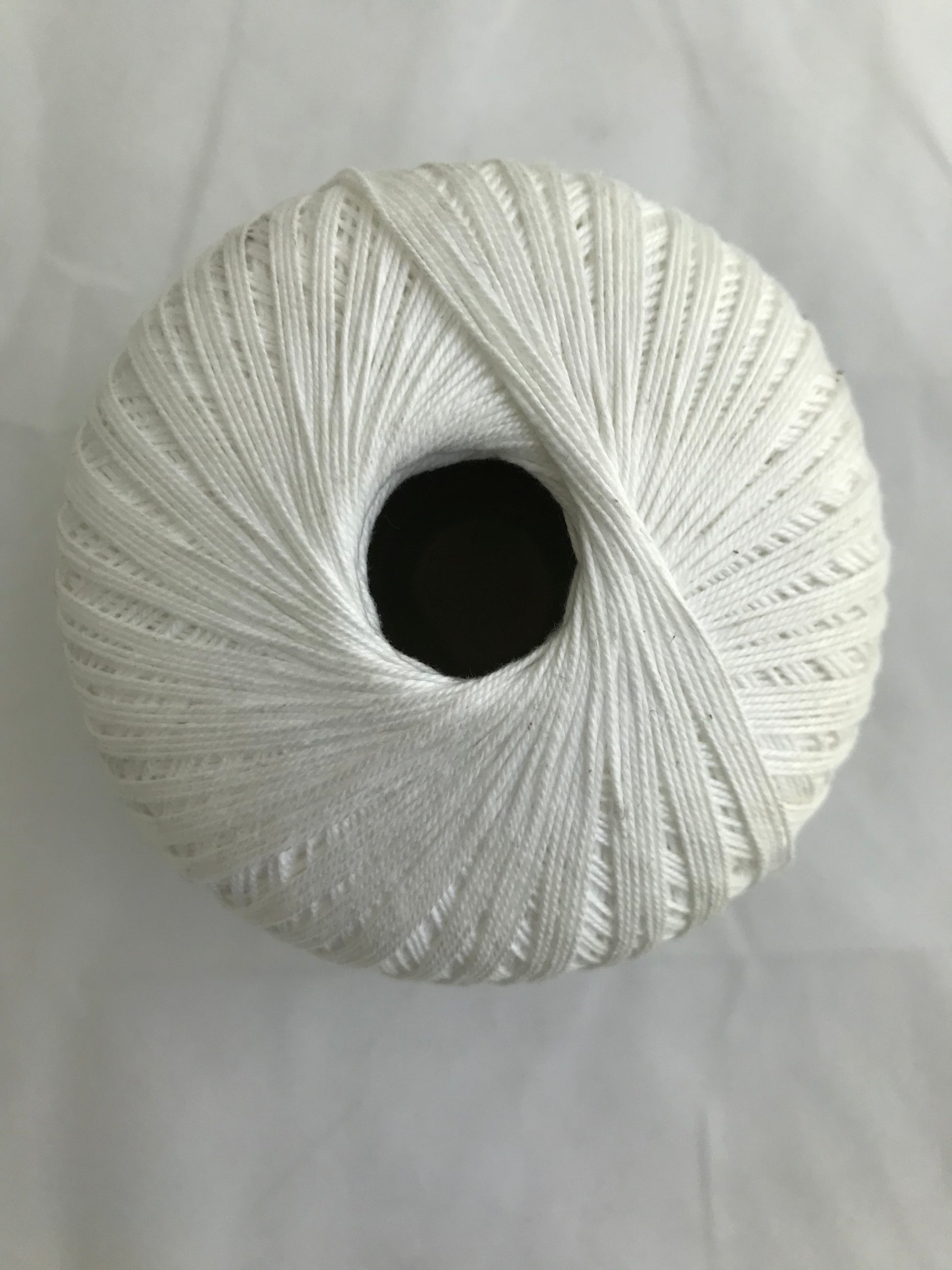 White skein of yarn on a white background