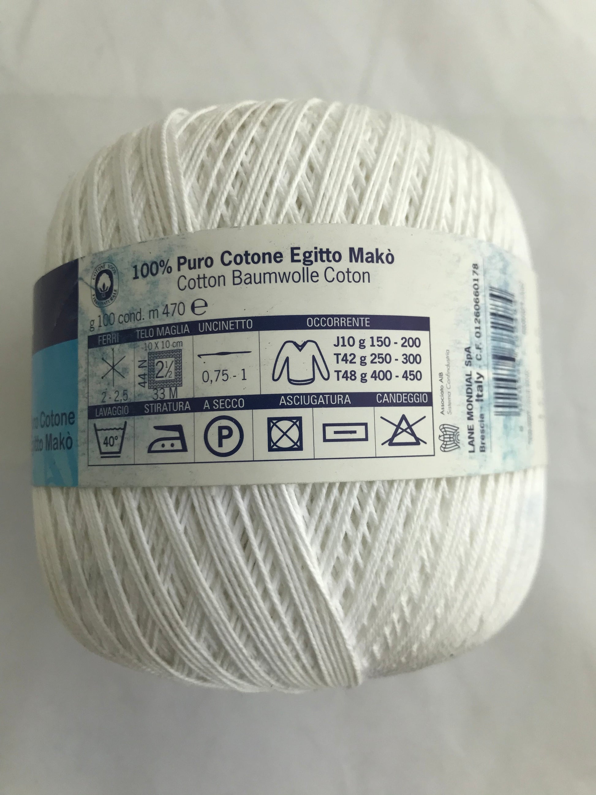 Ball of white yarn with labels on a light gray background