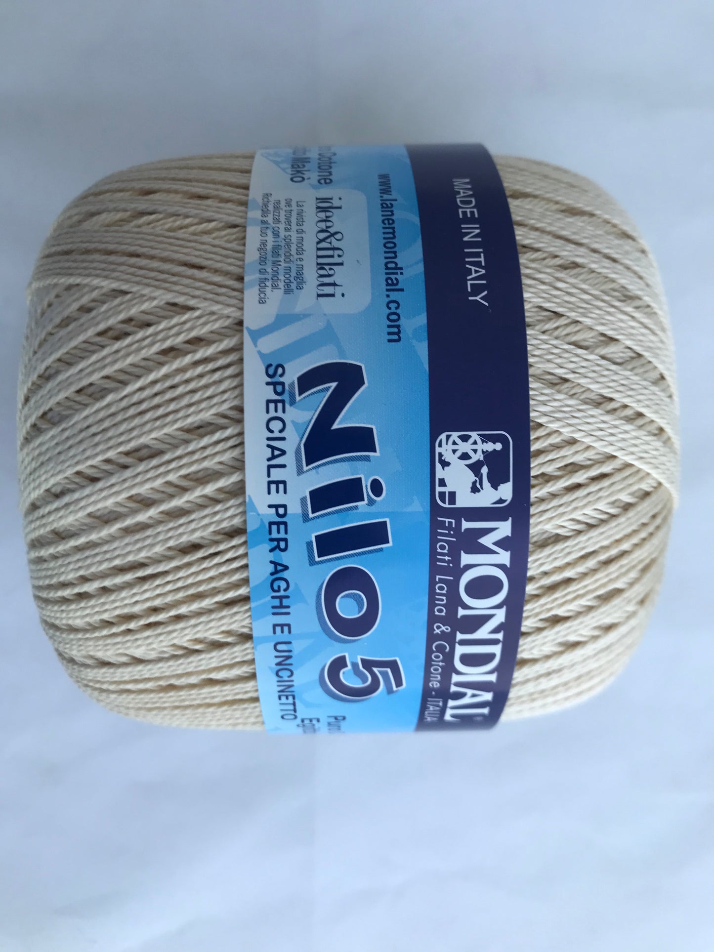 Ball of yarn with Mondial Nilo 5 label on a light gray background