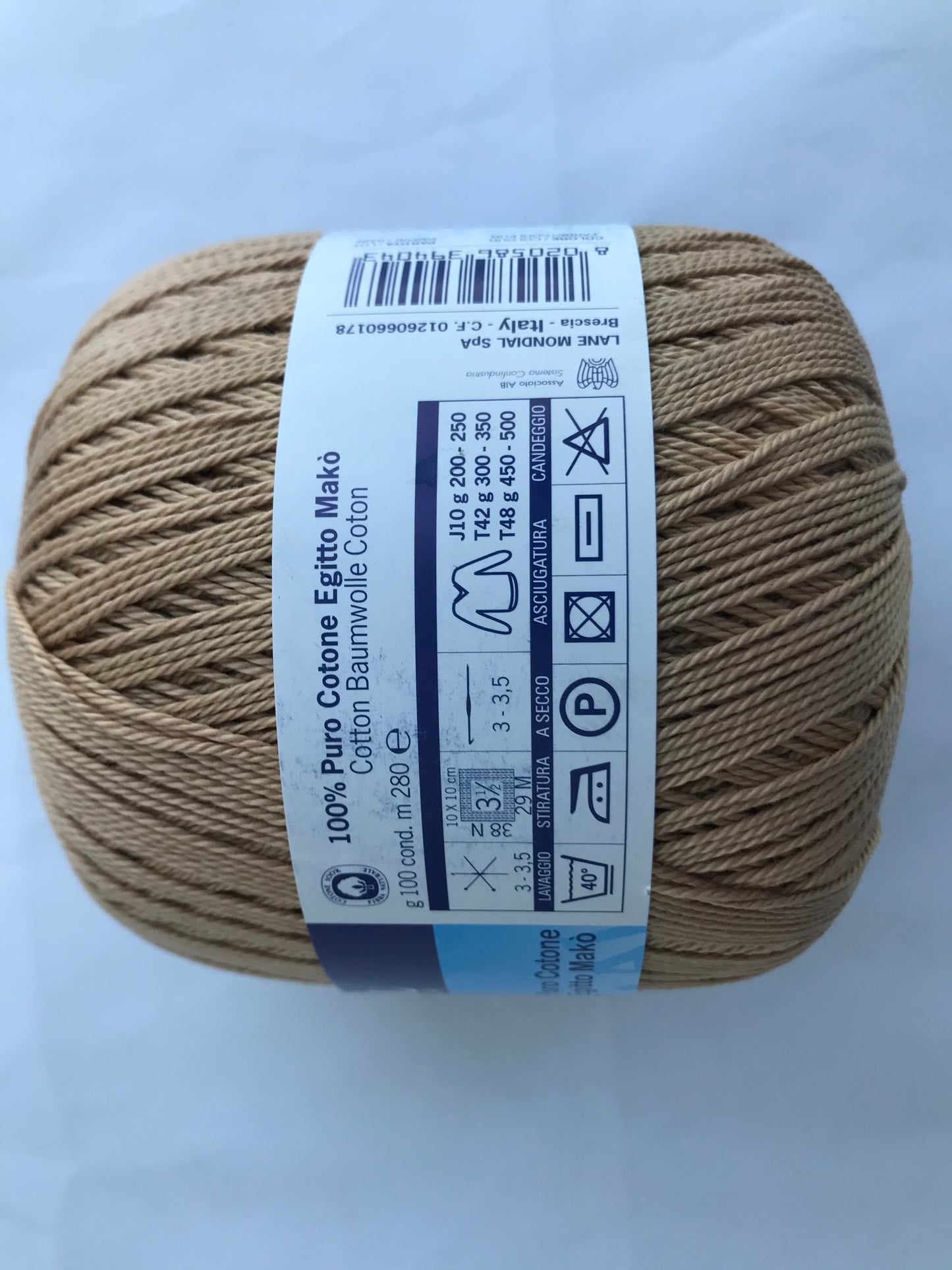 Ball of yarn with a label on a light gray background