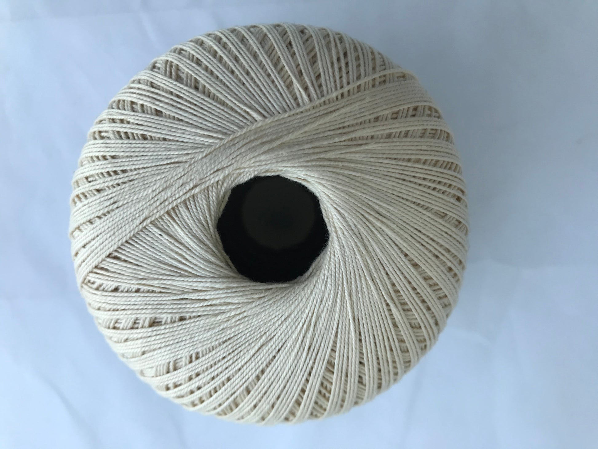 Ball of yarn on a light blue background