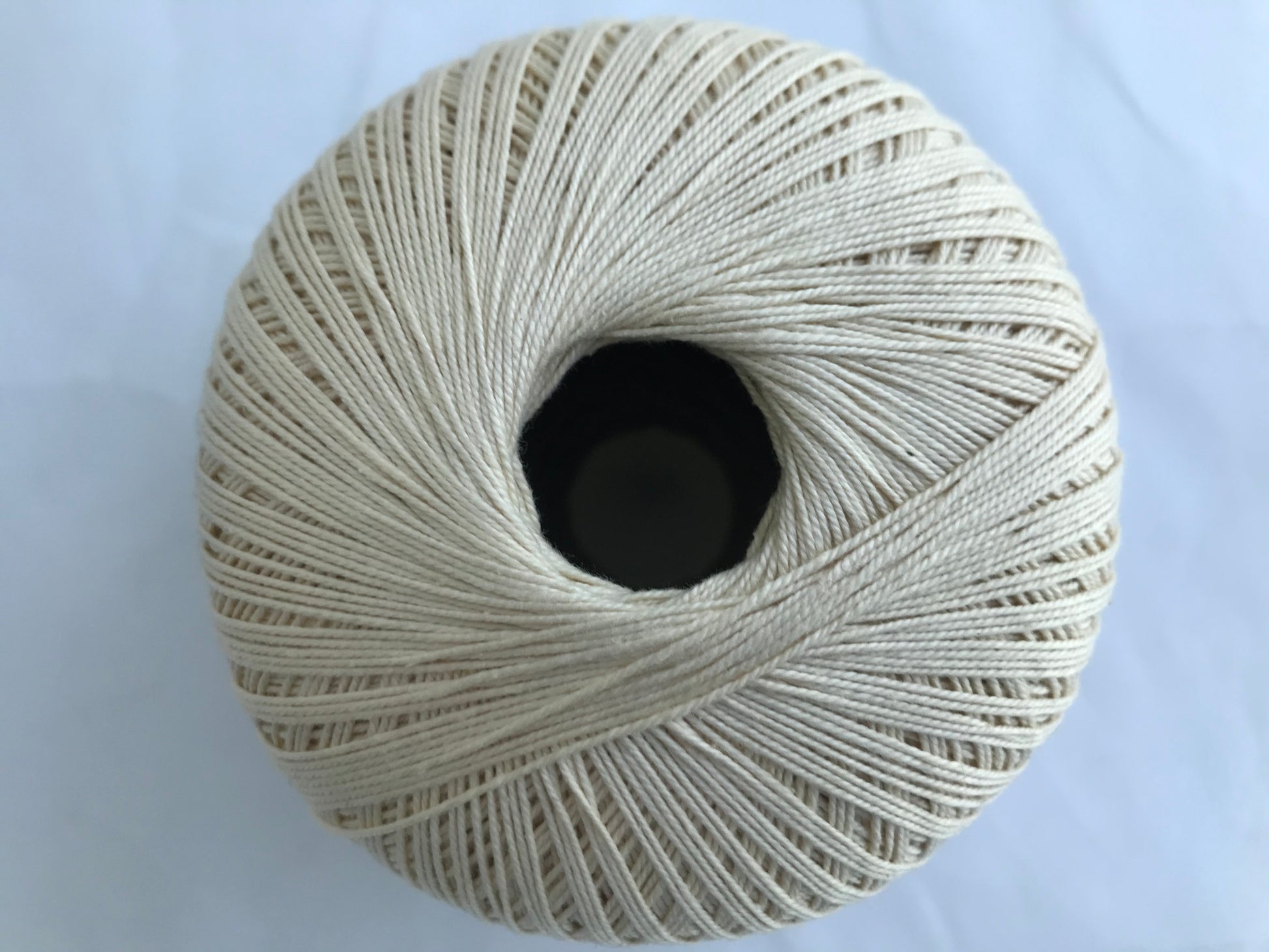 Ball of yarn on a light blue background