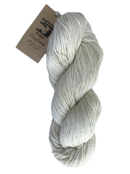 Ball of gray yarn with a label on a white background