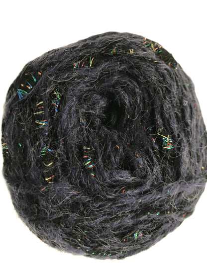 Ball of dark gray yarn with multicolored fibers on a white background