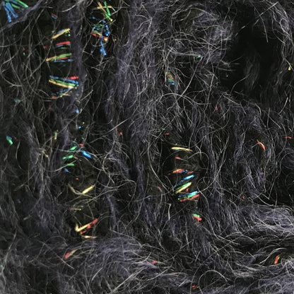 Ball of dark gray yarn with multicolored fibers on a white background
