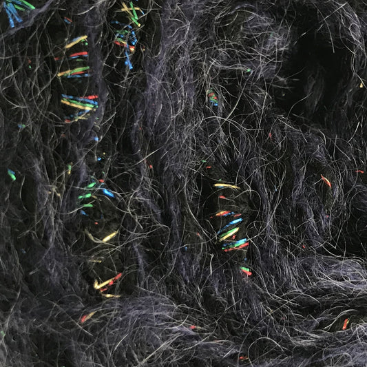Ball of dark gray yarn with multicolored fibers on a white background