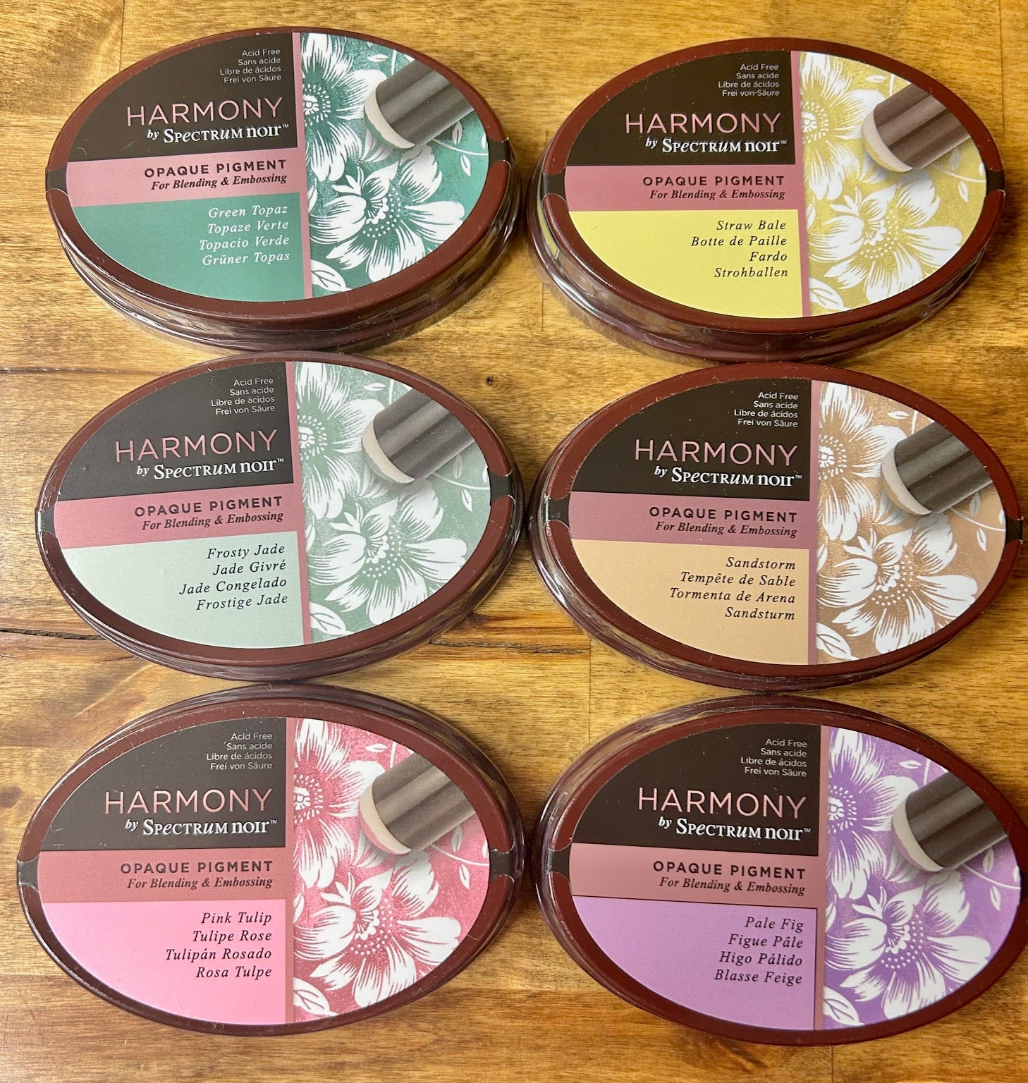 An image of a product box for Spectrum Noir archival pigment inks, featuring the colors Gold Plate, Silver Ingot, Ancient Bronze, and Pewter.