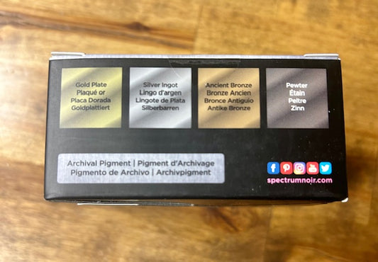 An image of a product box for Spectrum Noir archival pigment inks, featuring the colors Gold Plate, Silver Ingot, Ancient Bronze, and Pewter.