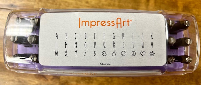 A purple case containing a set of ImpressArt Lollipop Uppercase Letters 4mm Metal Stamps. 
