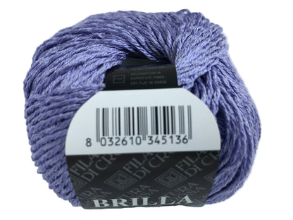 Ball of purple yarn with a label on a white background