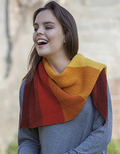Woman wearing a colorful knitted shawl outdoors