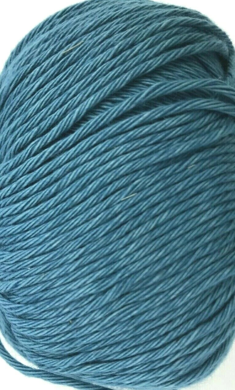 Close-up of a ball of blue yarn on a white background