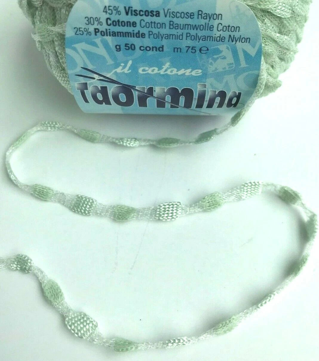 Ball of yarn with a label and a knitted sample on a white background