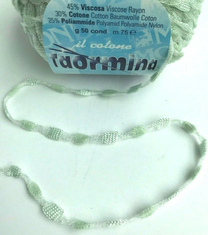 Ball of yarn with a label and a knitted sample on a white background