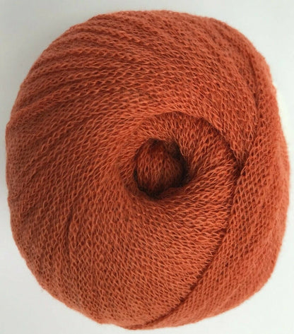 Ball of rust-colored yarn on a white background