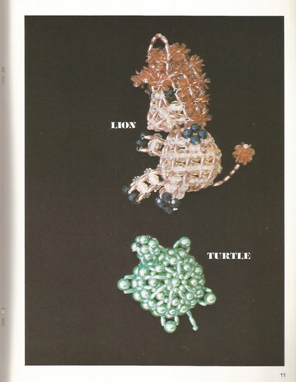 Beaded lion and turtle figurines on a dark background