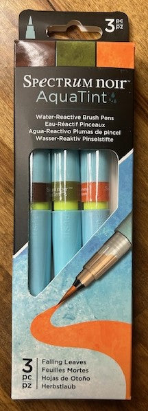 A 3-pack of Spectrum Noir AquaTint water-reactive brush pens in the 'Falling Leaves' color set. The pens are dye-based and dispensed through a fine nylon brush.