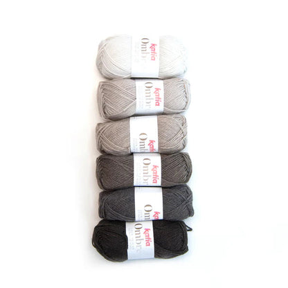 Six skeins of yarn in white, gray, and black on a white background with 'Katia Ombre' labels.