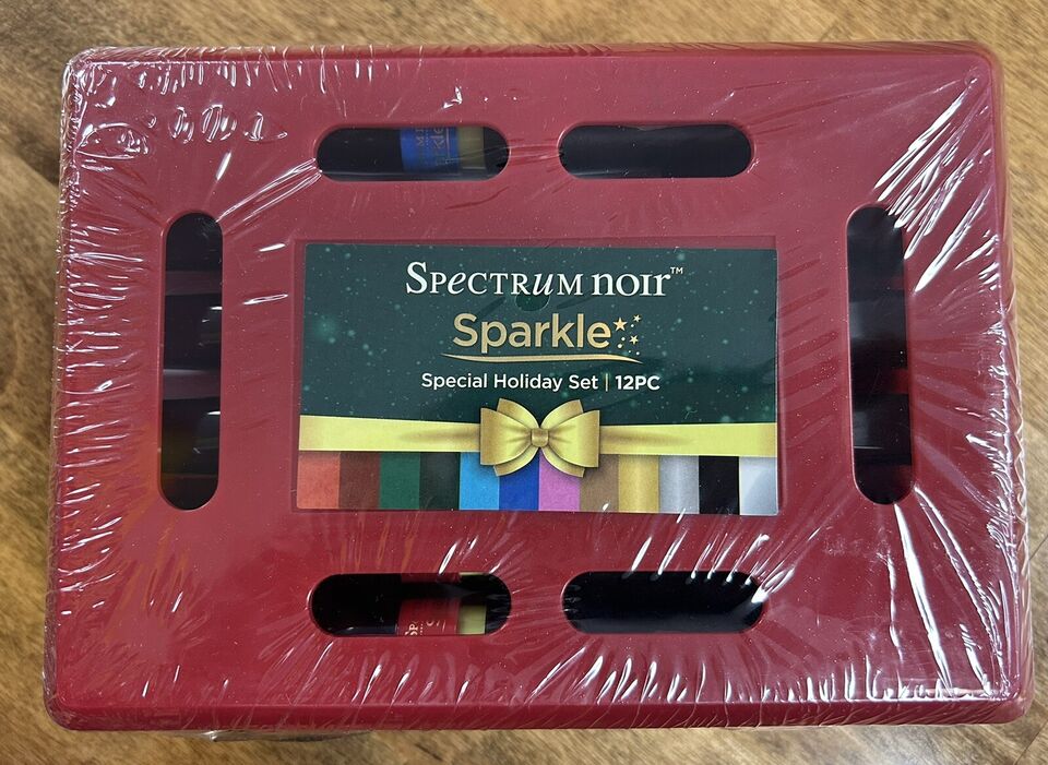 A red packaging of Spectrum Noir Sparkle Brush Markers Holiday 12 pc Set with a clear window showing the color pots in a festive arrangement.