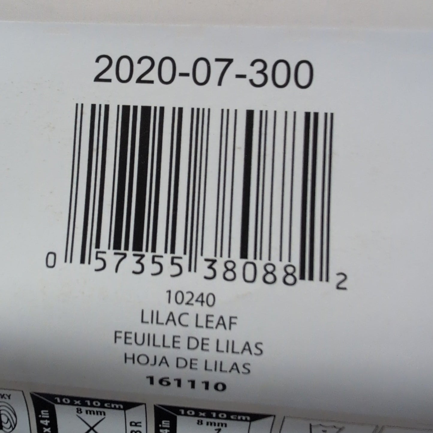 Close-up of a Bernat yarn label with a barcode and product details.