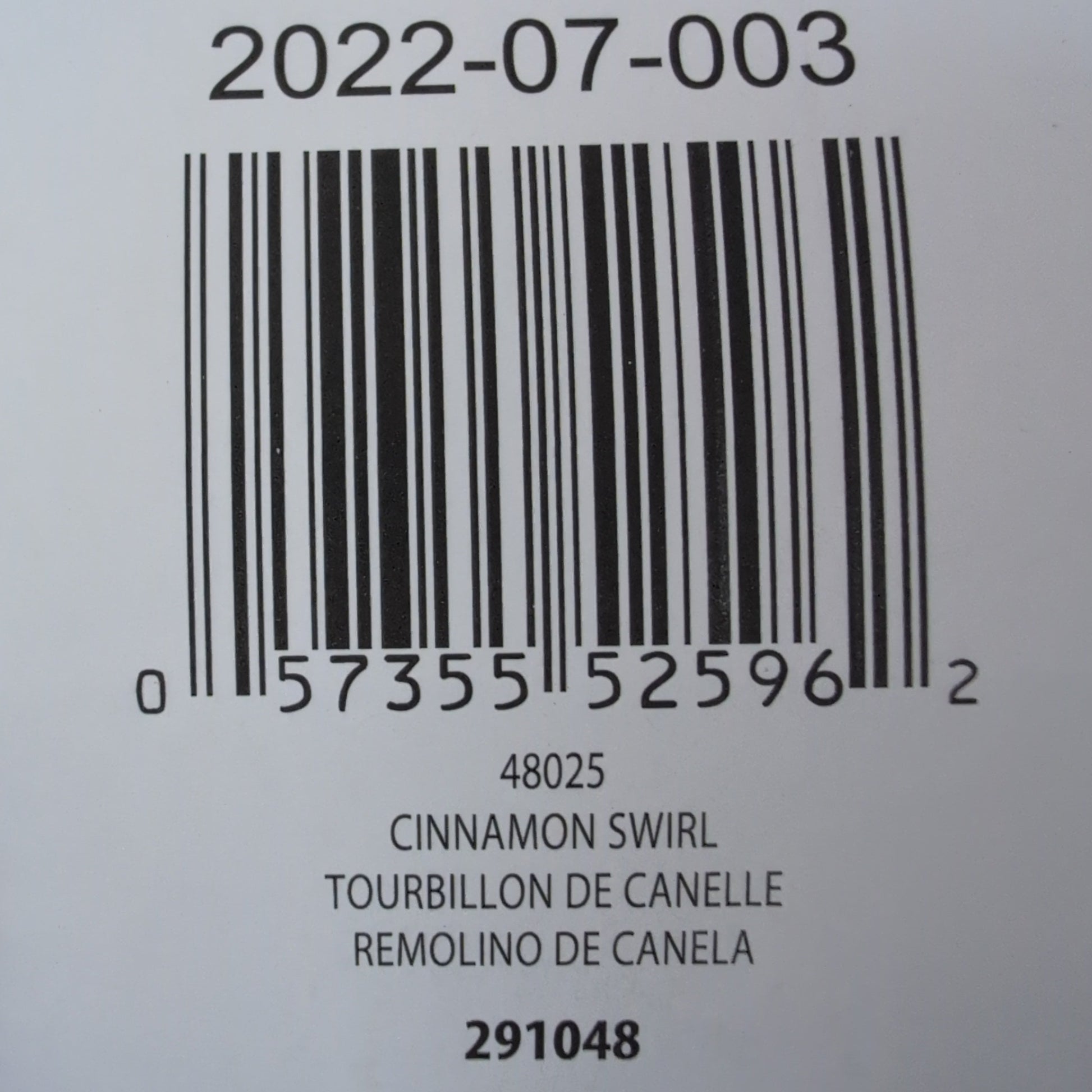 Close-up of a product label with a barcode and text on a beige background