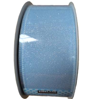 Spool of blue glitter ribbon with Kirkland brand label on a white background