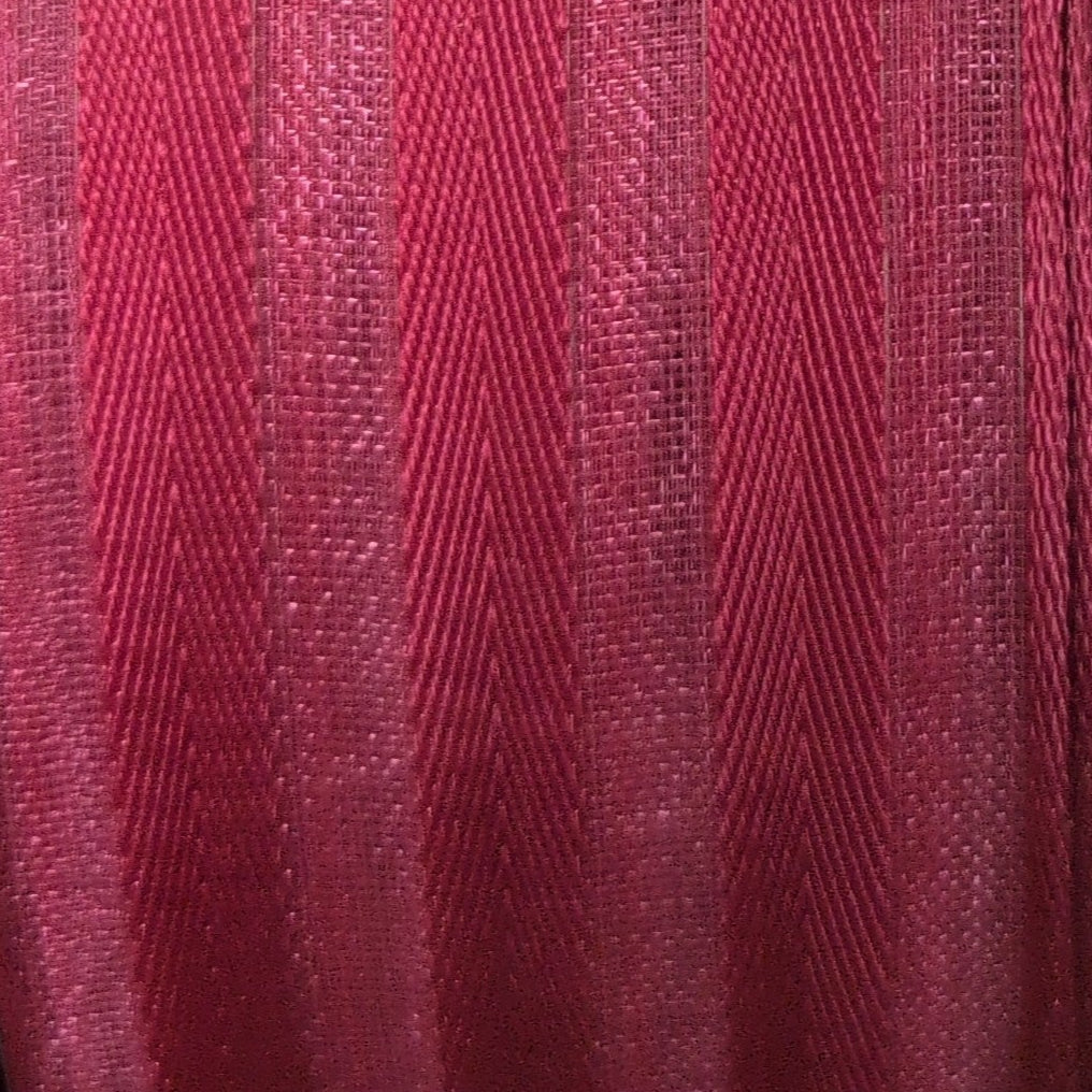 Spool of red ribbon on a white background