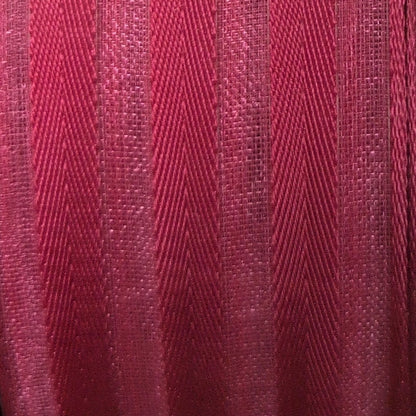 Spool of red ribbon on a white background