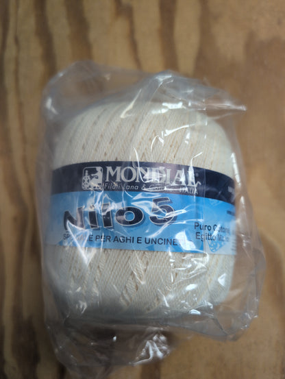 Ball of yarn with a label on a wooden surface